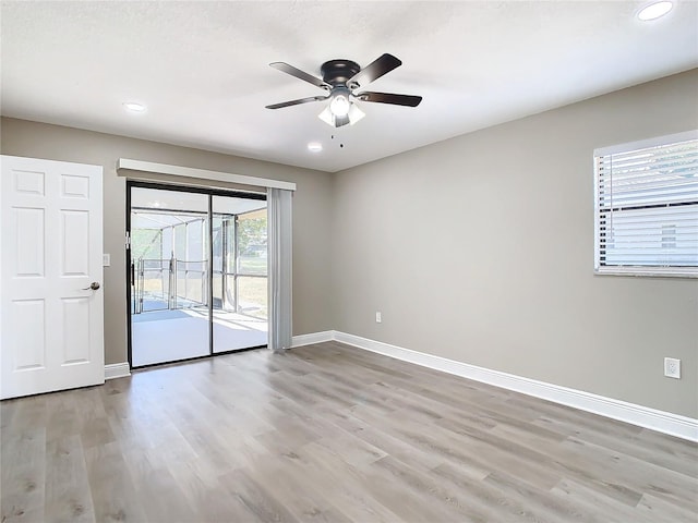 empty room featuring ceiling fan and light wood-type flooring