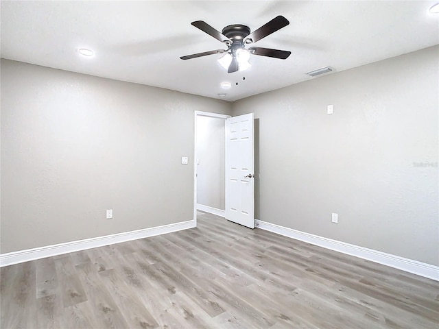 spare room with light hardwood / wood-style floors and ceiling fan