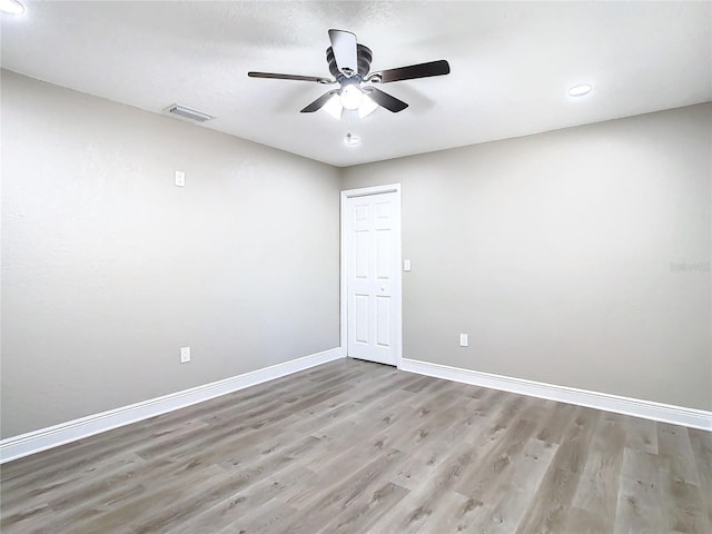 unfurnished room with ceiling fan and light hardwood / wood-style floors