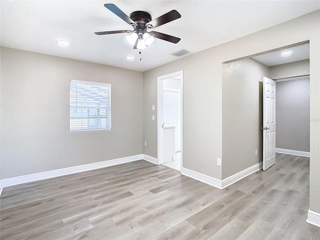 empty room with ceiling fan and light wood-type flooring