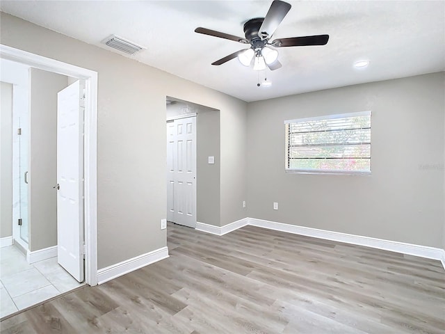 unfurnished room with ceiling fan and light hardwood / wood-style flooring