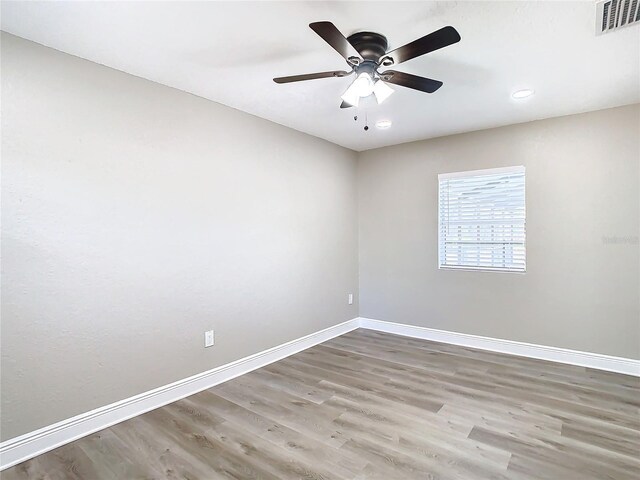 spare room featuring hardwood / wood-style flooring and ceiling fan