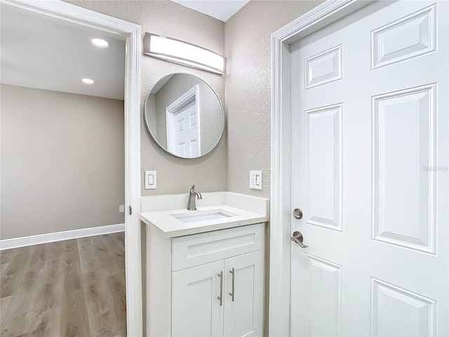 bathroom with vanity and wood-type flooring