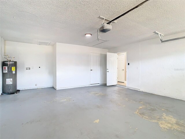 garage featuring electric water heater and a garage door opener