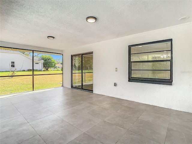 unfurnished room with a textured ceiling