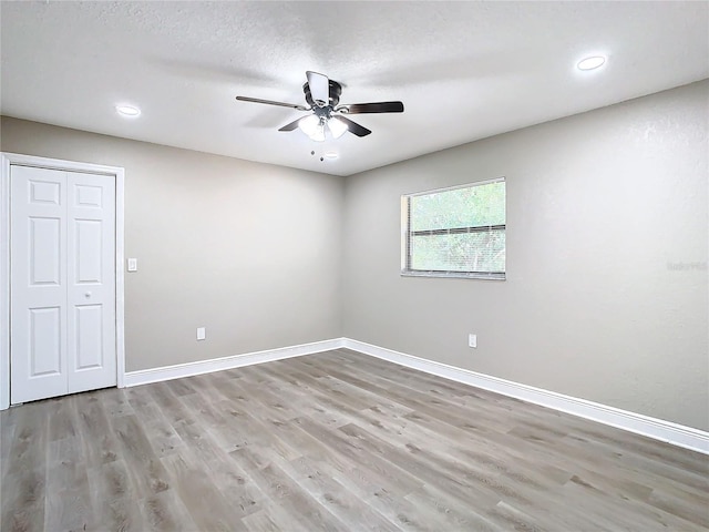 unfurnished room featuring light hardwood / wood-style flooring and ceiling fan