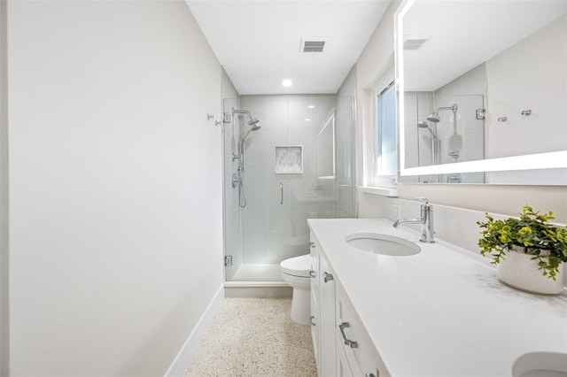 bathroom with vanity, an enclosed shower, and toilet