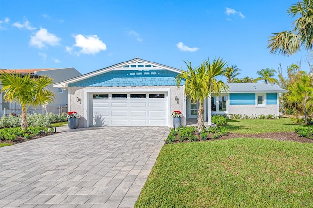 ranch-style home featuring a garage and a front yard