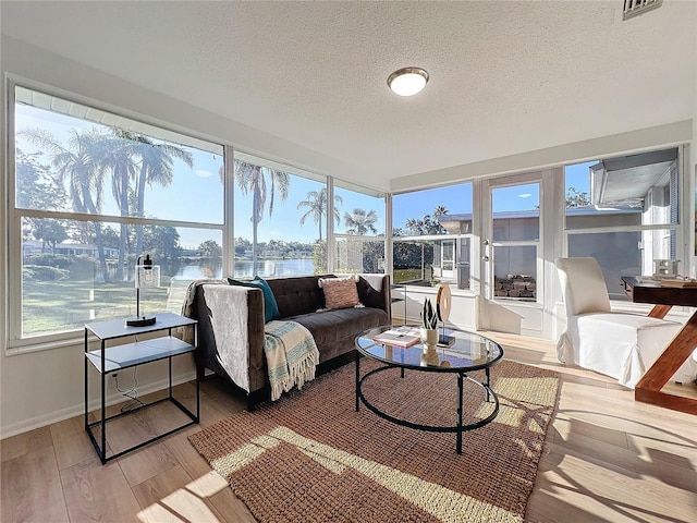 sunroom / solarium with a water view