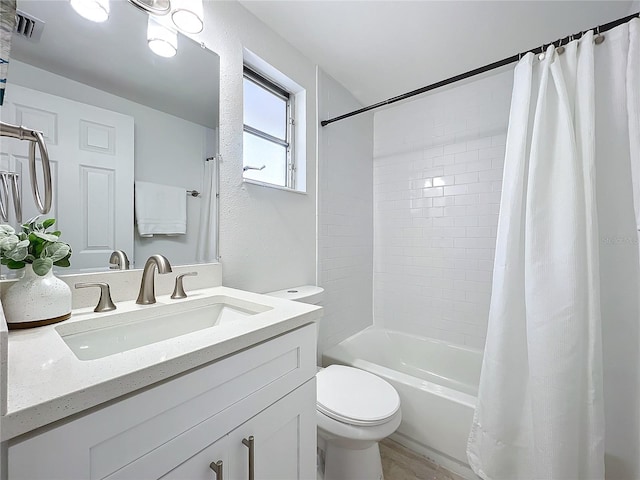 full bathroom with shower / bath combo with shower curtain, vanity, and toilet