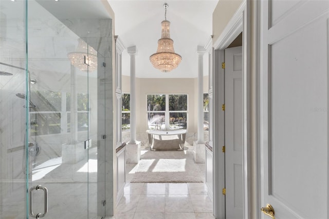 full bathroom with a notable chandelier, ornate columns, a shower stall, and a freestanding bath