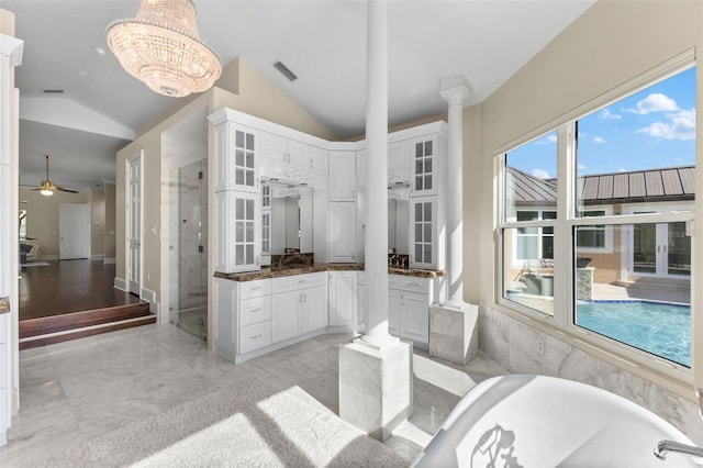 full bath featuring a bathtub, visible vents, vaulted ceiling, a shower stall, and vanity