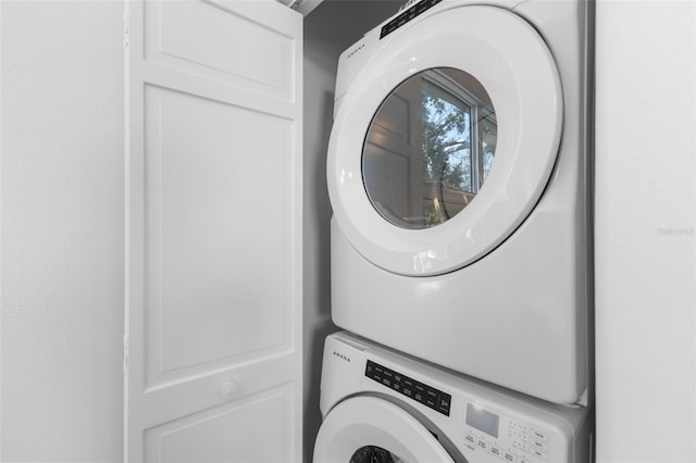 laundry area with laundry area and stacked washer / drying machine