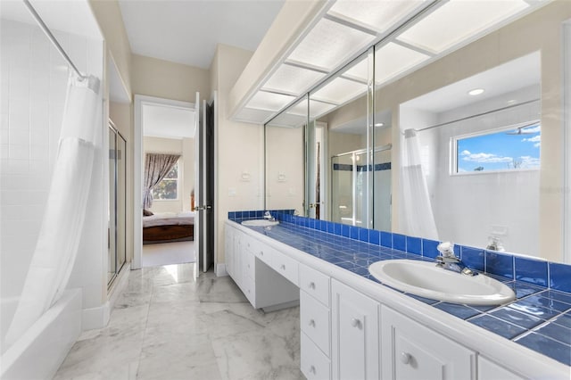 bathroom featuring double vanity, connected bathroom, a shower with shower curtain, marble finish floor, and a sink