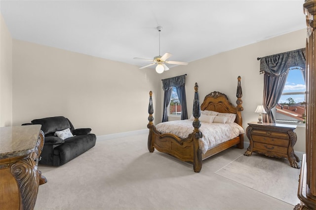 carpeted bedroom featuring ceiling fan and baseboards