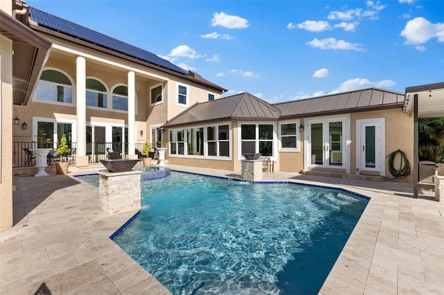 outdoor pool featuring a patio and french doors