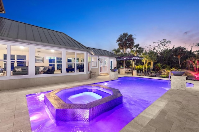 view of pool featuring a patio area, a pool with connected hot tub, and outdoor dry bar