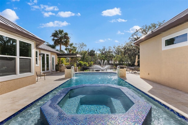 view of swimming pool featuring a patio area, a pool with connected hot tub, and french doors