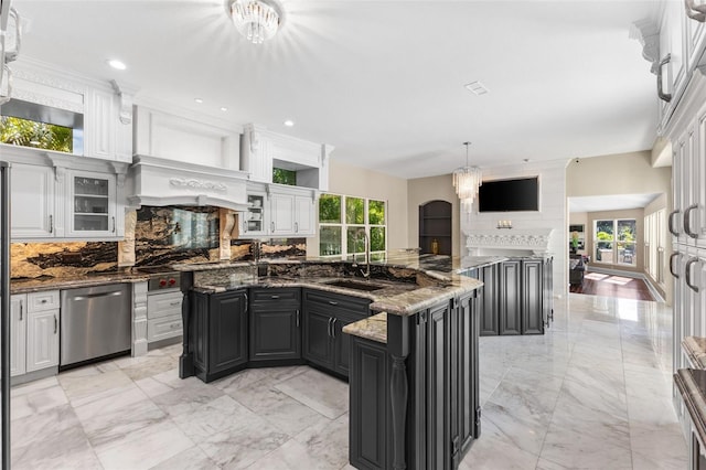 kitchen with a sink, marble finish floor, tasteful backsplash, and dishwasher