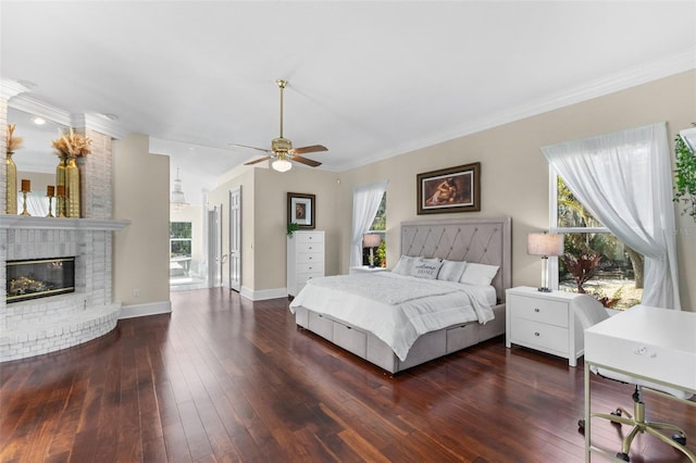 bedroom with ornamental molding, a ceiling fan, a brick fireplace, baseboards, and hardwood / wood-style flooring