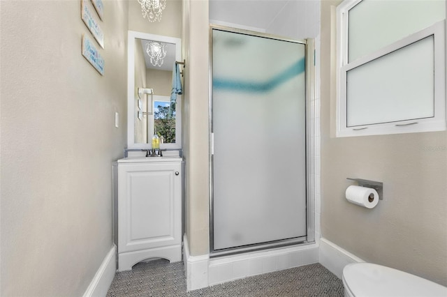 bathroom with a sink, a shower stall, and toilet