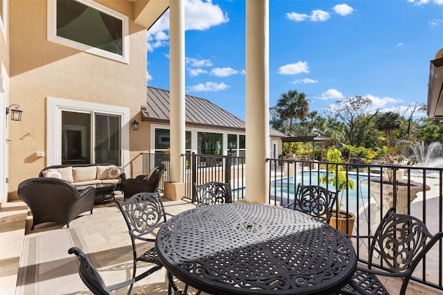 balcony with an outdoor hangout area, a patio, and outdoor dining space