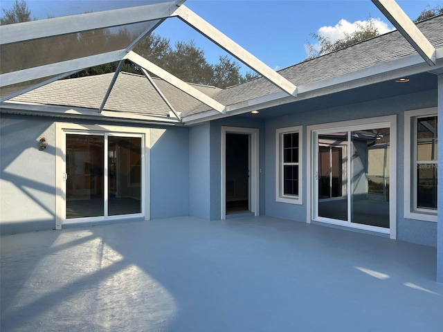 exterior space featuring a lanai, stucco siding, and a patio