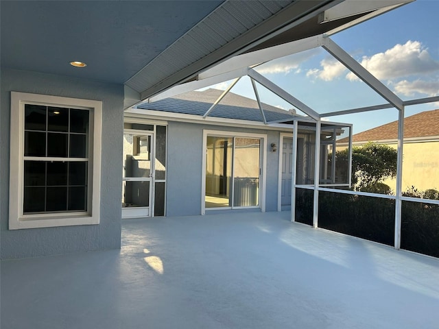 view of patio / terrace featuring glass enclosure