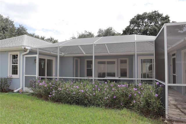 view of property exterior with glass enclosure, stucco siding, and a shingled roof