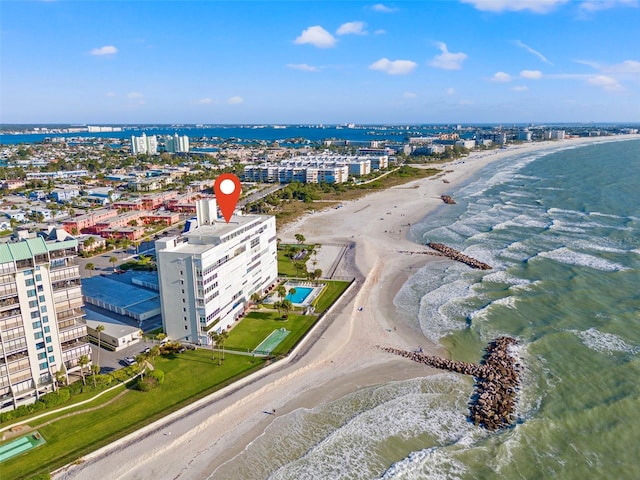 drone / aerial view featuring a water view and a beach view