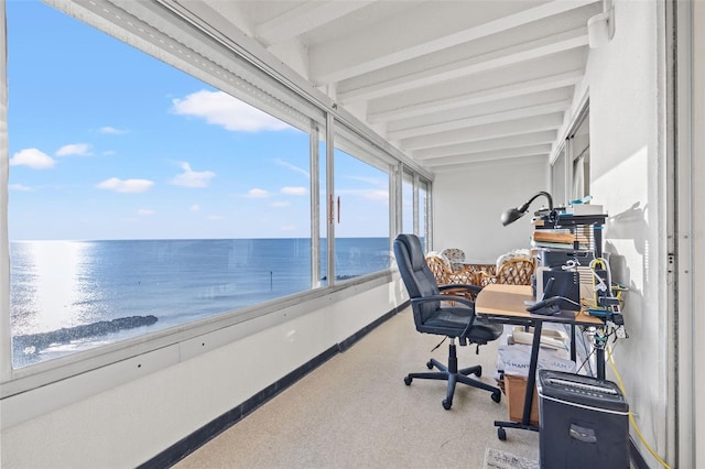 office space with beam ceiling and a water view