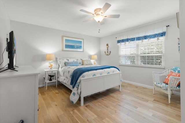 bedroom with ceiling fan and light hardwood / wood-style floors