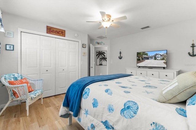 bedroom with ceiling fan, a closet, and light hardwood / wood-style flooring