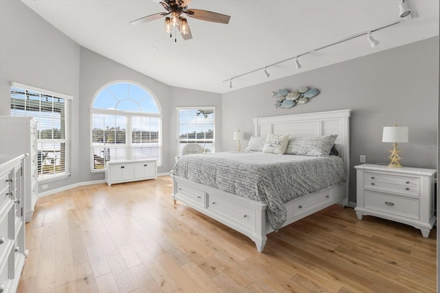 bedroom featuring lofted ceiling, ceiling fan, light hardwood / wood-style floors, and track lighting