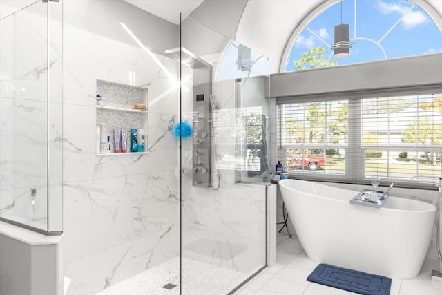 bathroom with shower with separate bathtub and tile walls