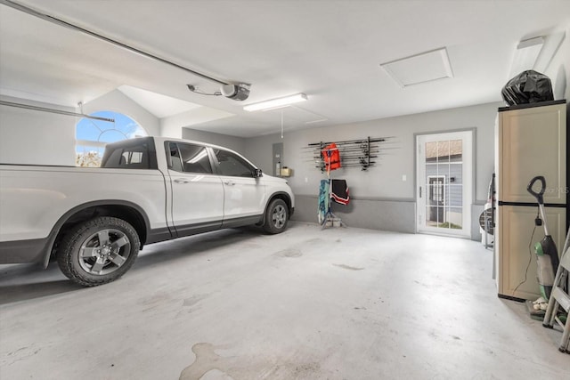 garage featuring electric panel and a garage door opener