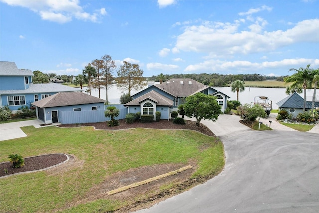 single story home with a water view and a front yard