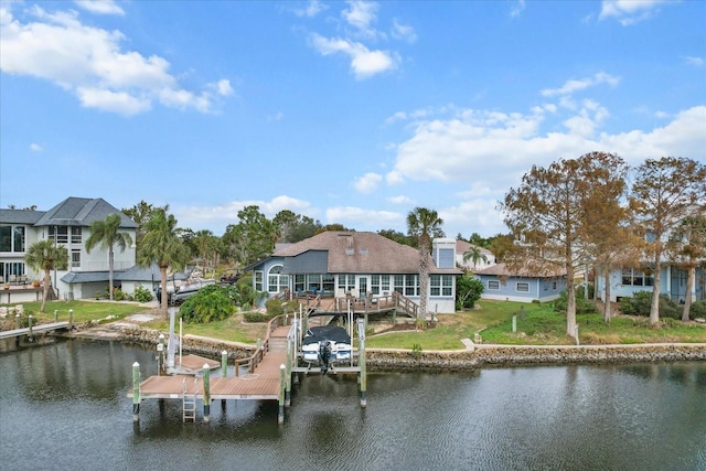 dock area featuring a lawn and a deck with water view