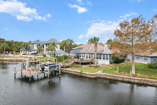 dock area with a water view and a lawn