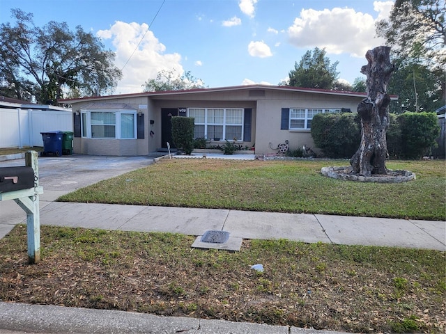 single story home featuring a front yard