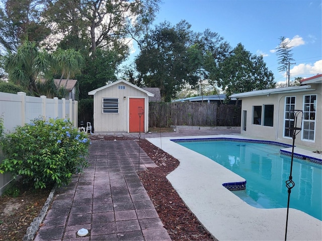 view of swimming pool with a storage unit