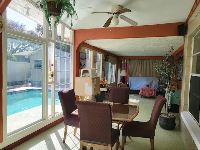 sunroom / solarium with ceiling fan and a healthy amount of sunlight