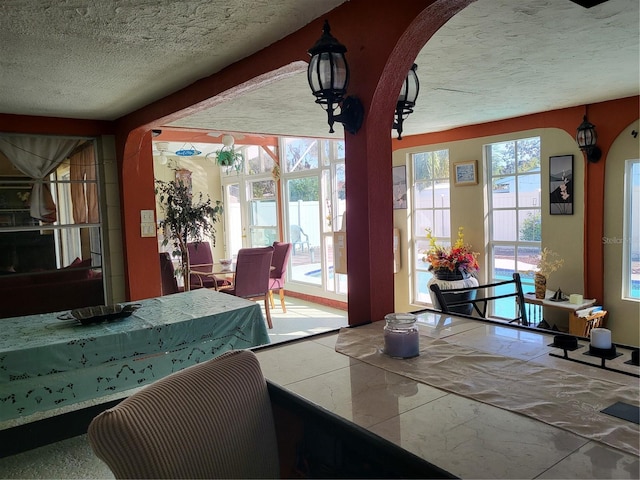 dining room featuring a wealth of natural light and a textured ceiling