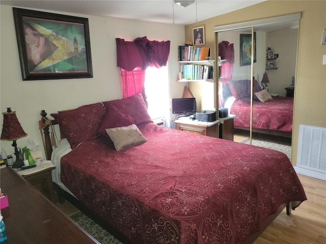 bedroom featuring light hardwood / wood-style flooring and a closet