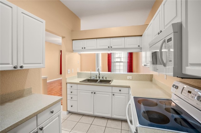 kitchen featuring white cabinetry and white appliances