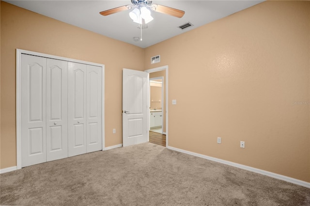 unfurnished bedroom featuring carpet flooring, ceiling fan, and a closet