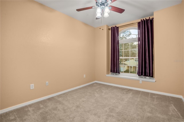 empty room with ceiling fan and light carpet