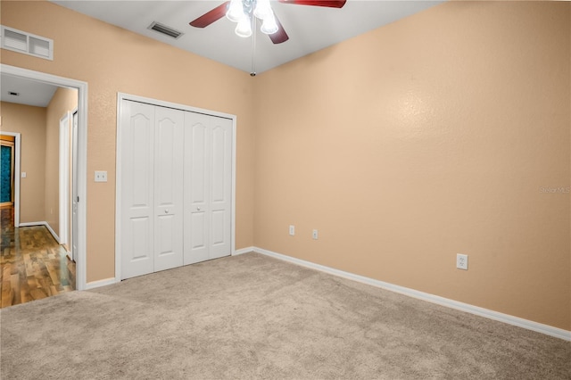 unfurnished bedroom with ceiling fan, carpet floors, and a closet