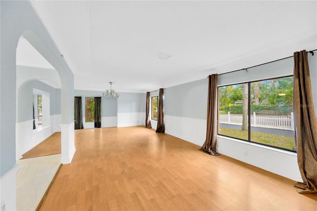 empty room featuring light hardwood / wood-style floors and an inviting chandelier