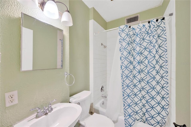 full bathroom featuring toilet, shower / bathtub combination with curtain, and sink